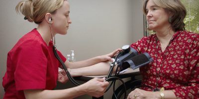 Testing woman's blood pressure